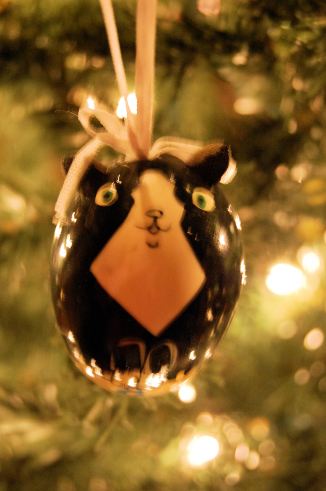 I've not had a tuxedo kitty in my adult life but this one of several of my kitty ornaments.  It's a hand painted egg one from Russia.  I like it very much and gives me hope that if the Cold War came to an end so can many other horrid things. 