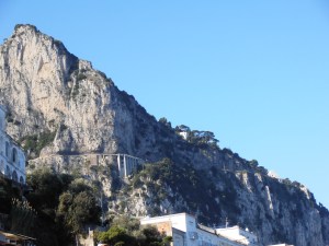 If you look there on the side of the rock you'll see the Etruscan road to Anacapri.  See it there with the supports?