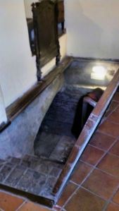 Look to the upper left corner and you'll see the foot board of the bed slid into the wall to allow the secret door to open to the Roman theater green room. The door is open showing the stairs.