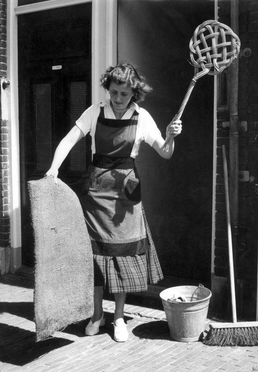 House Wife with carpet beater, no known copyright restrictions, Used via The Commons on Flickr From the Nationaal Archief of the Netherlands.